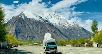 a truck is parked in front of a mountain