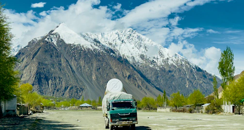 a truck is parked in front of a mountain