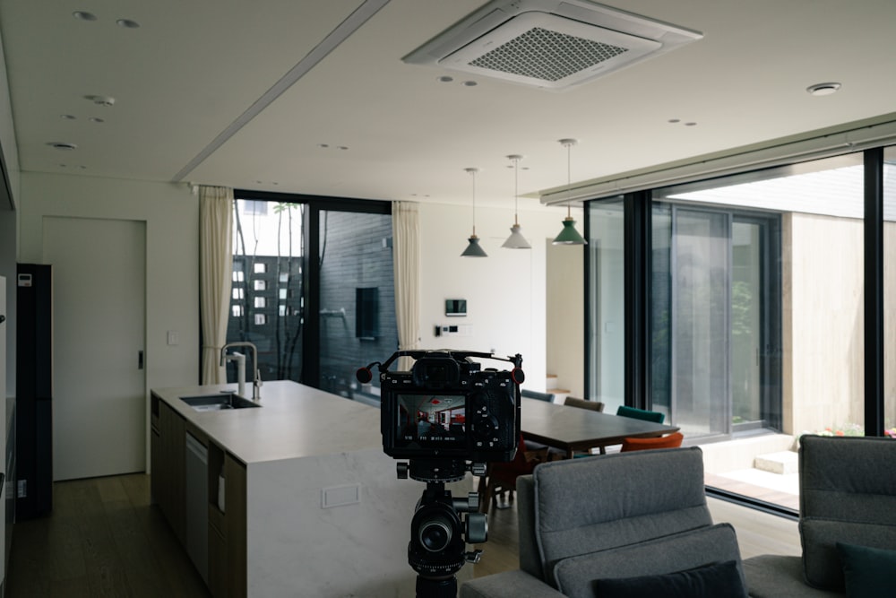a camera set up in front of a kitchen and living room