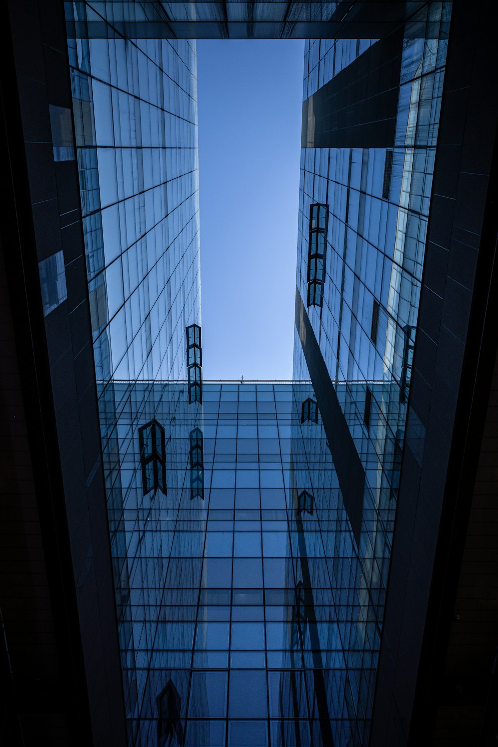 looking up at a very tall building with a sky in the background