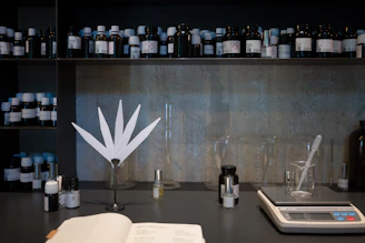 a table topped with lots of bottles and a book