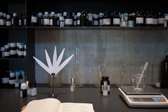 a table topped with lots of bottles and a book