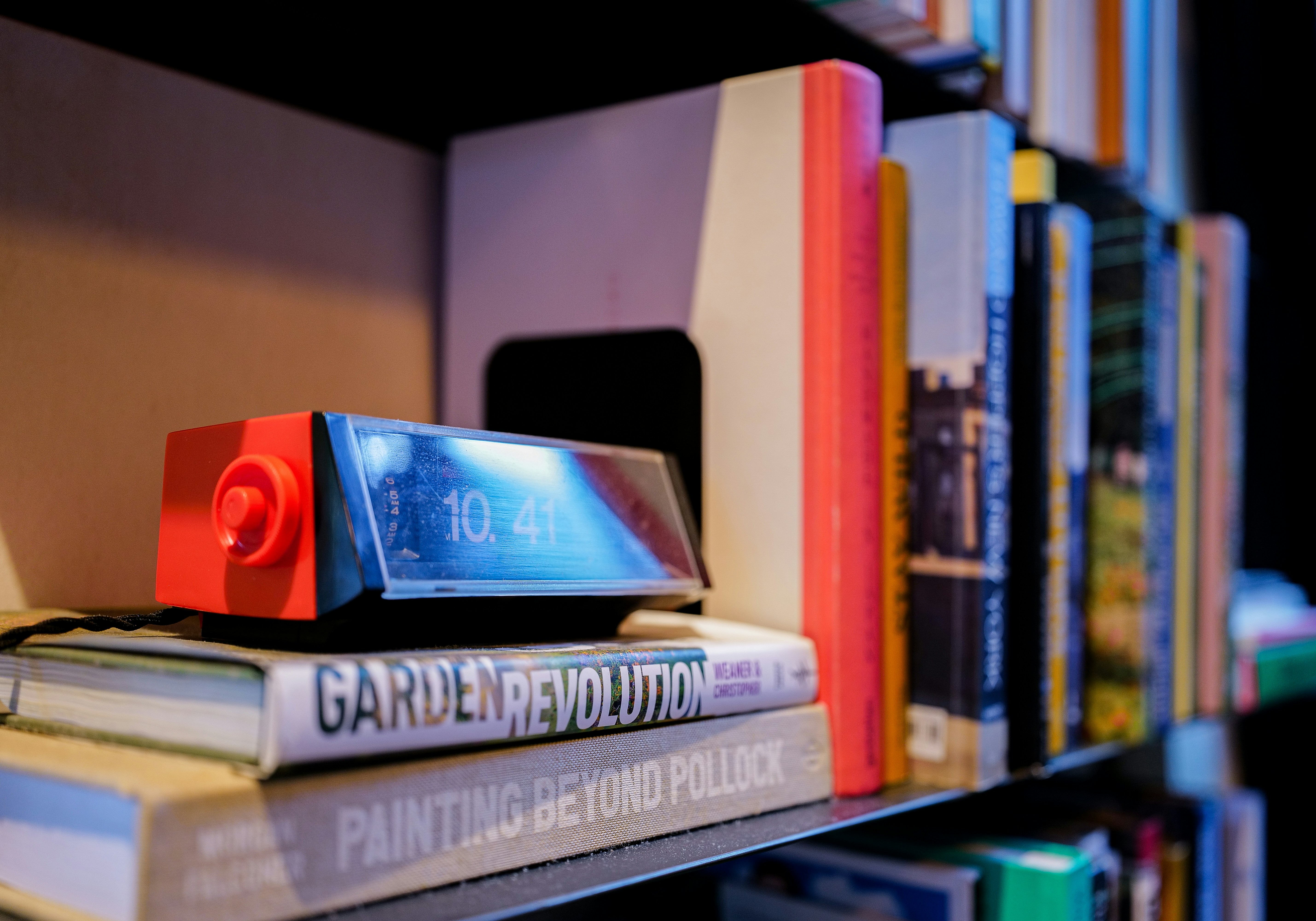 a stack of books sitting on top of a shelf