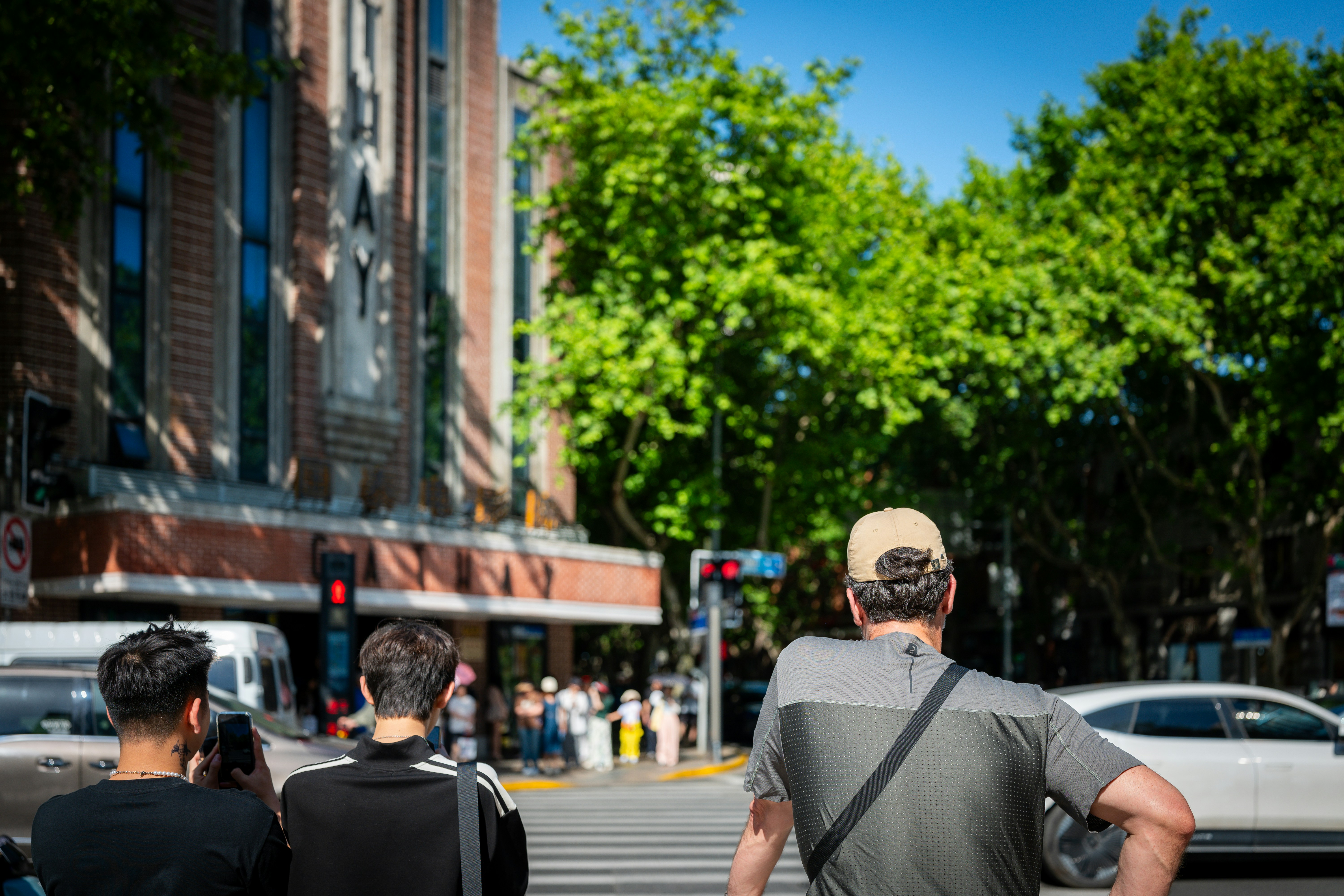 a group of people walking across a street