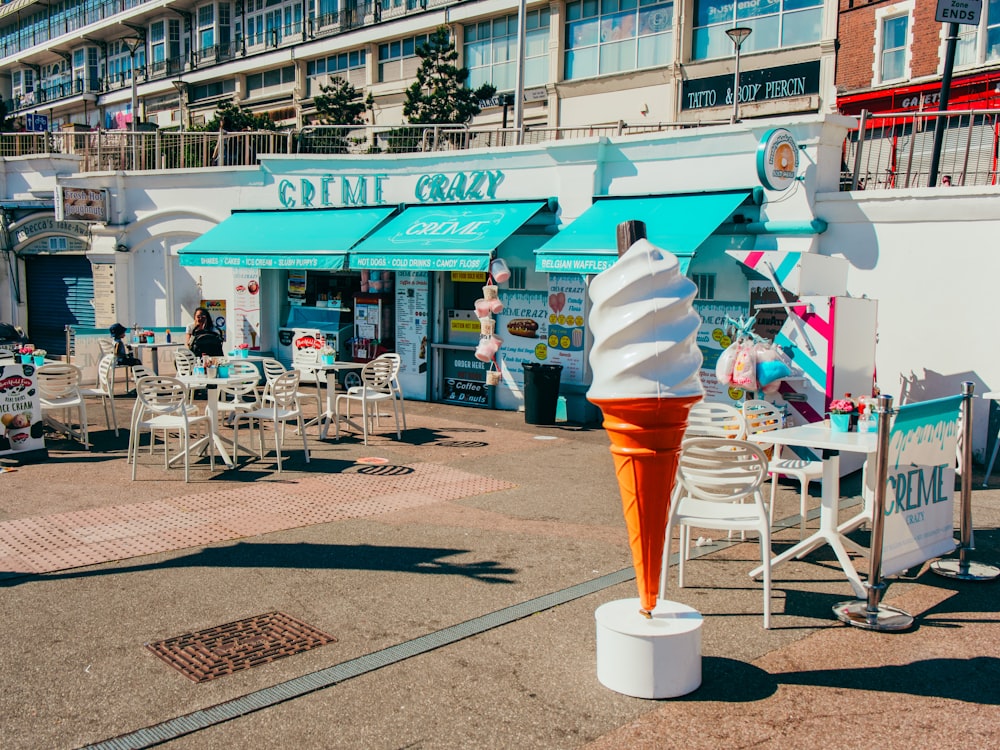 an ice cream cone sitting in the middle of a sidewalk