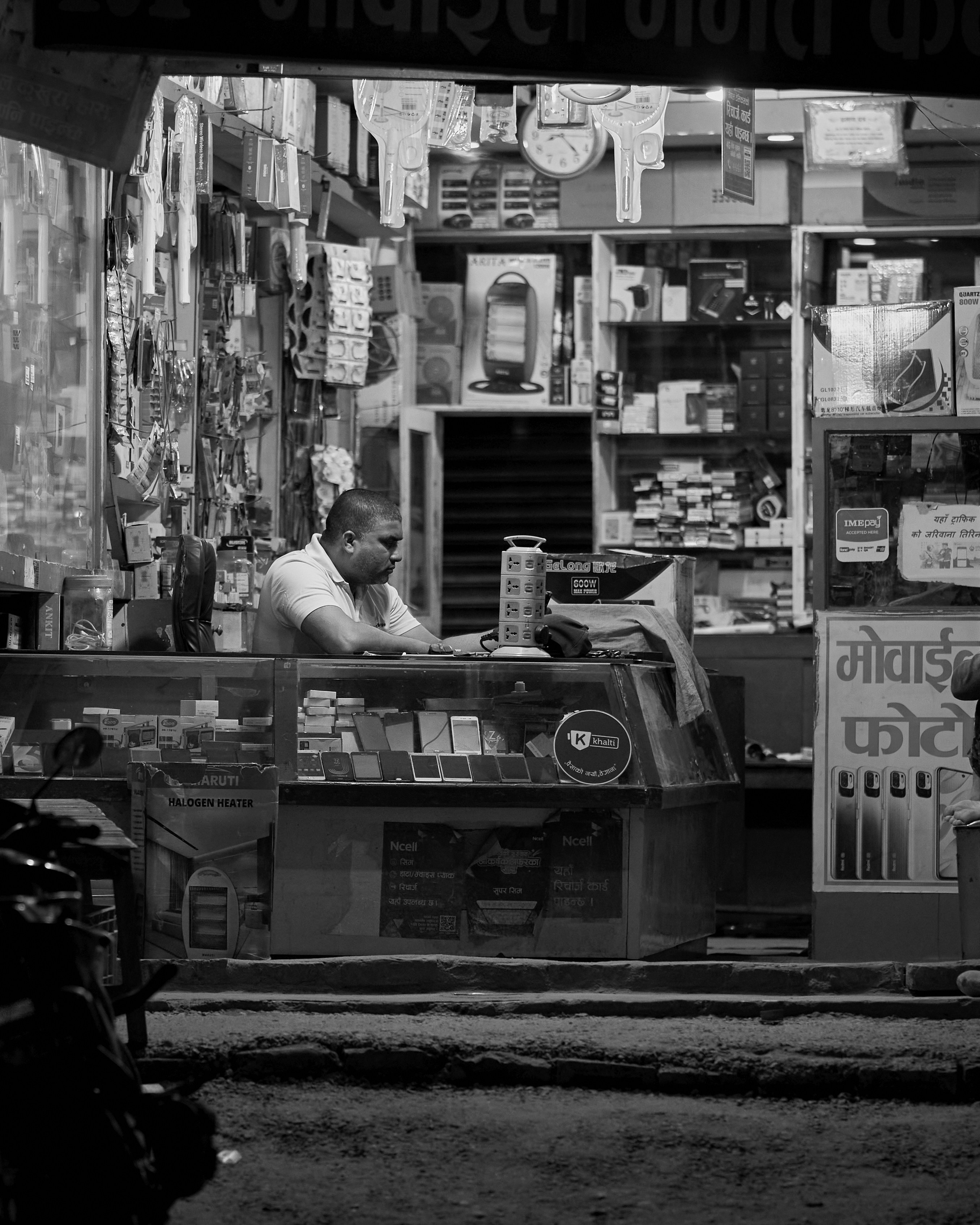 a black and white photo of a man at a store