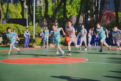 a group of young men playing a game of basketball