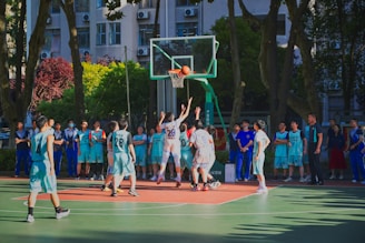 a group of young men playing a game of basketball