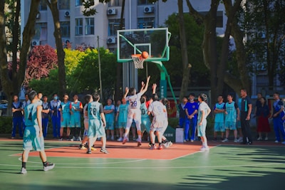 a group of young men playing a game of basketball