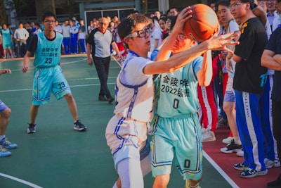 a group of young men playing a game of basketball