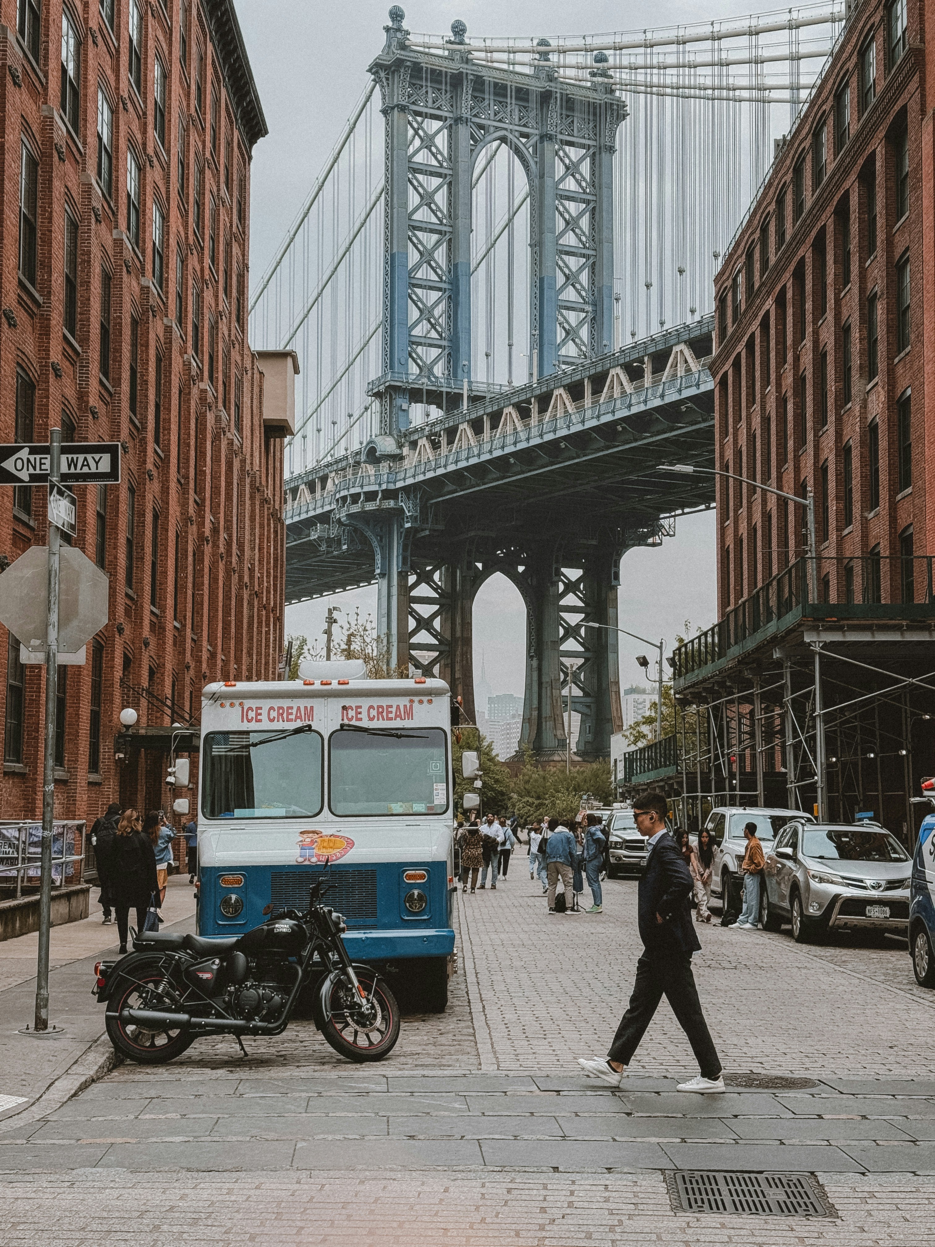 a man crossing a street in front of a truck