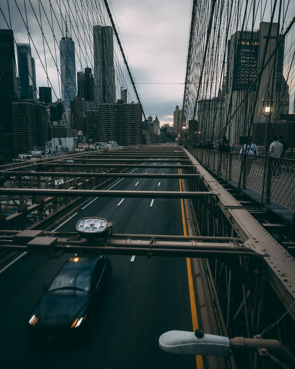 a car driving across a bridge in a city