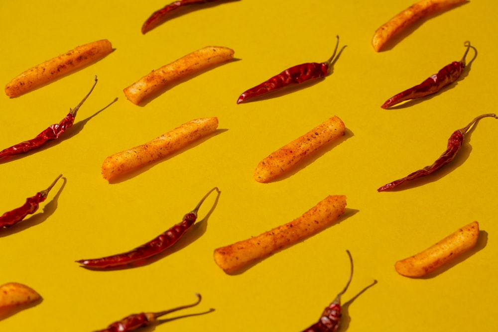a group of chili peppers sitting on top of a yellow surface