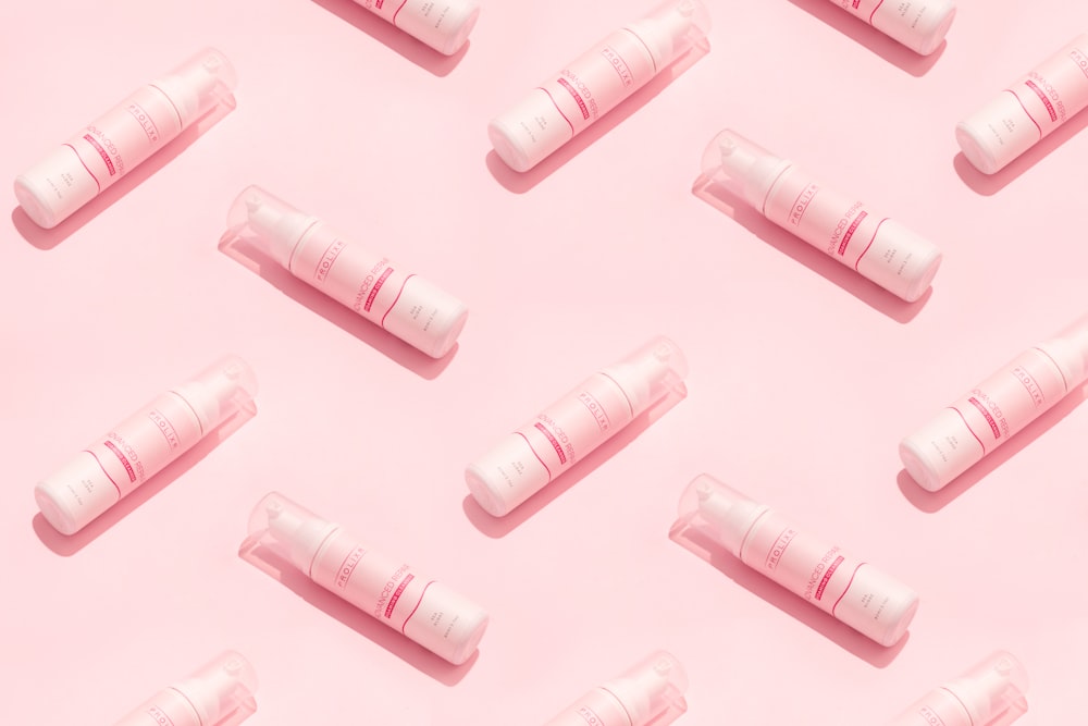 a group of pink tubes sitting on top of a pink surface