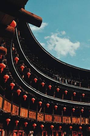 a large building with lots of red lanterns hanging from it's sides