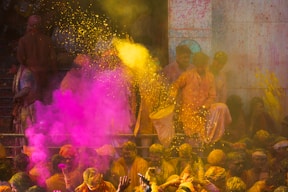 a group of people celebrating holi with colored powder