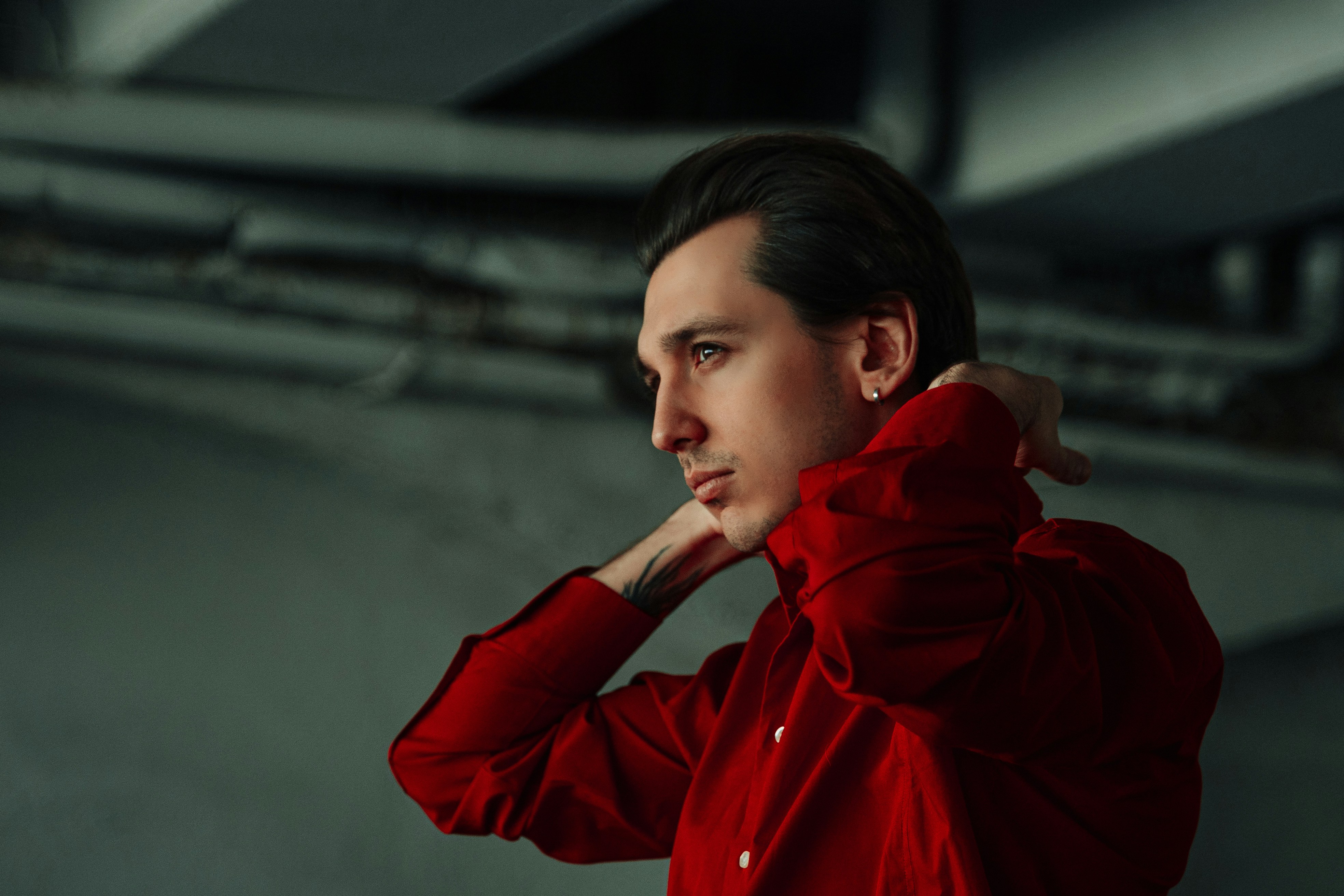 a man in a red shirt posing for a picture