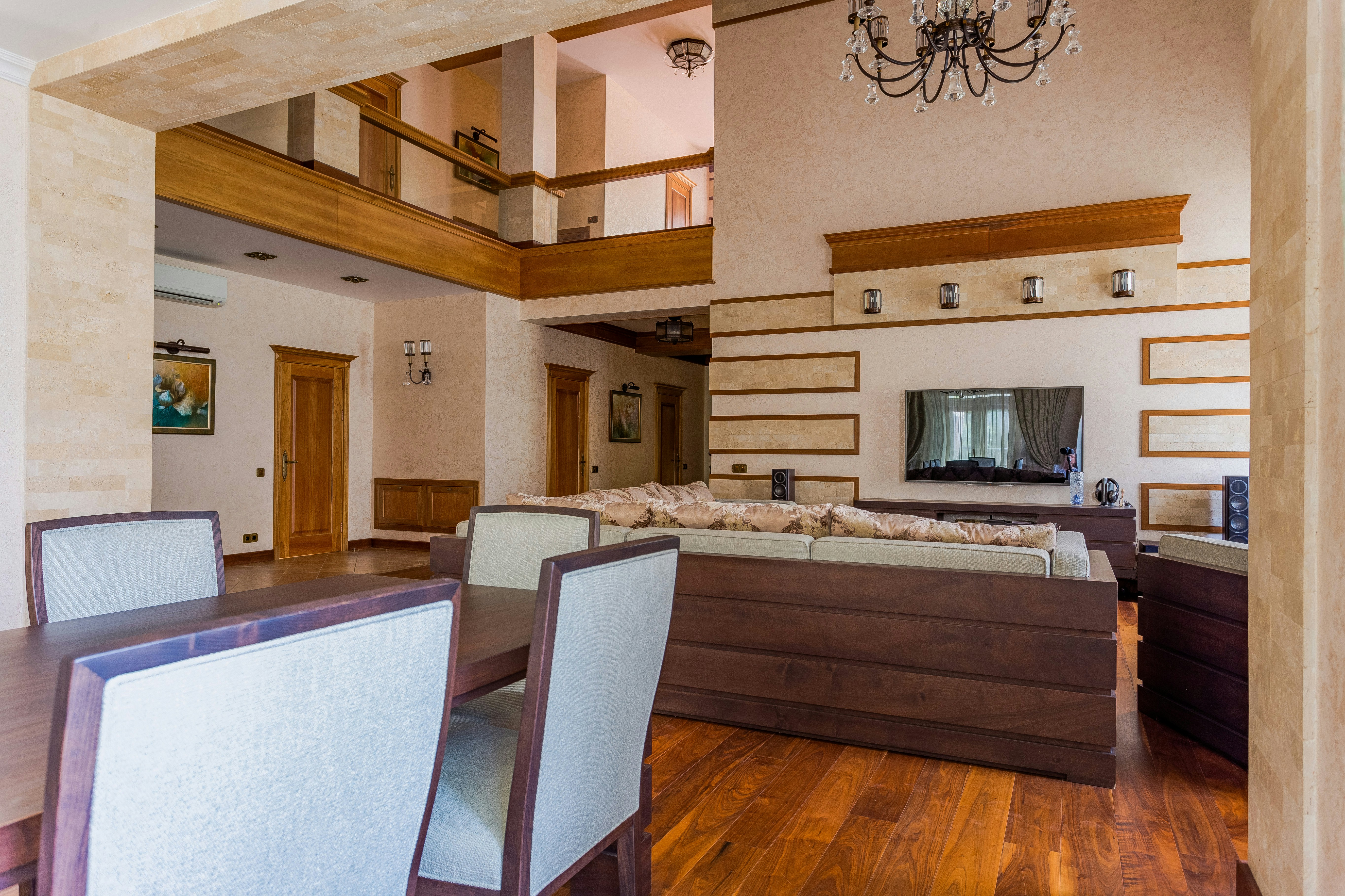 a living room filled with furniture and a chandelier