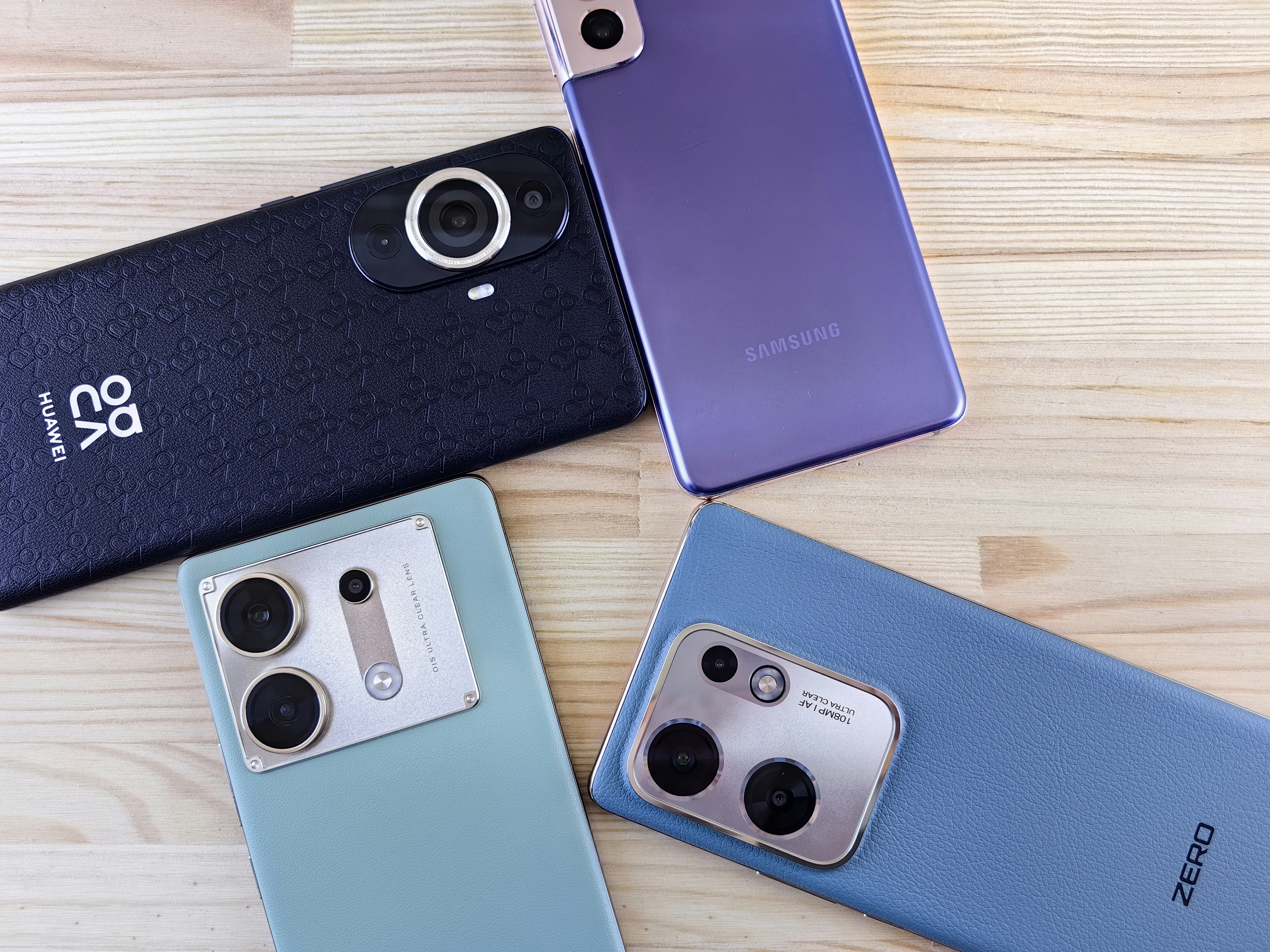 a group of three cell phones sitting on top of a wooden table