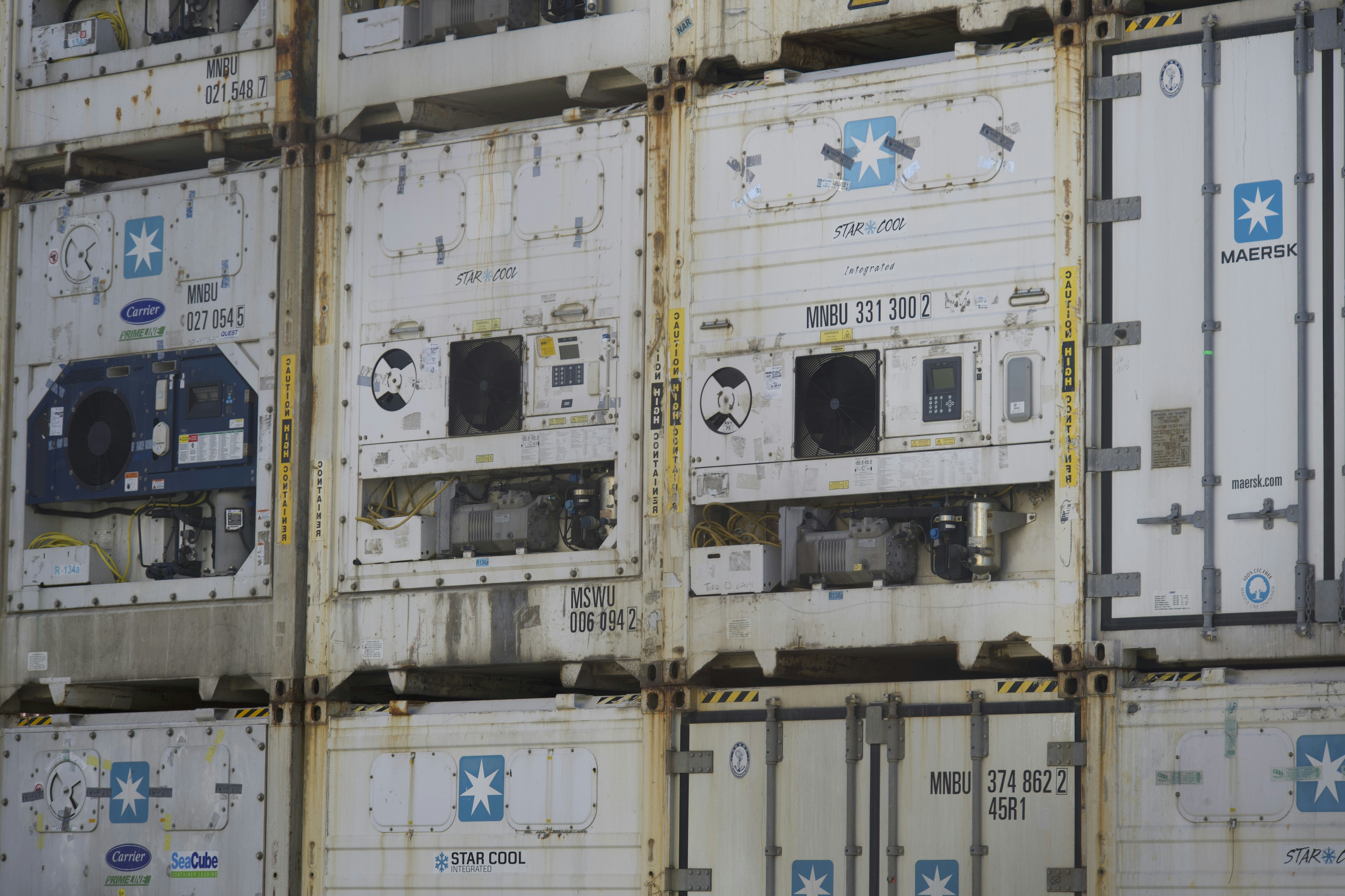 a bunch of containers stacked on top of each other