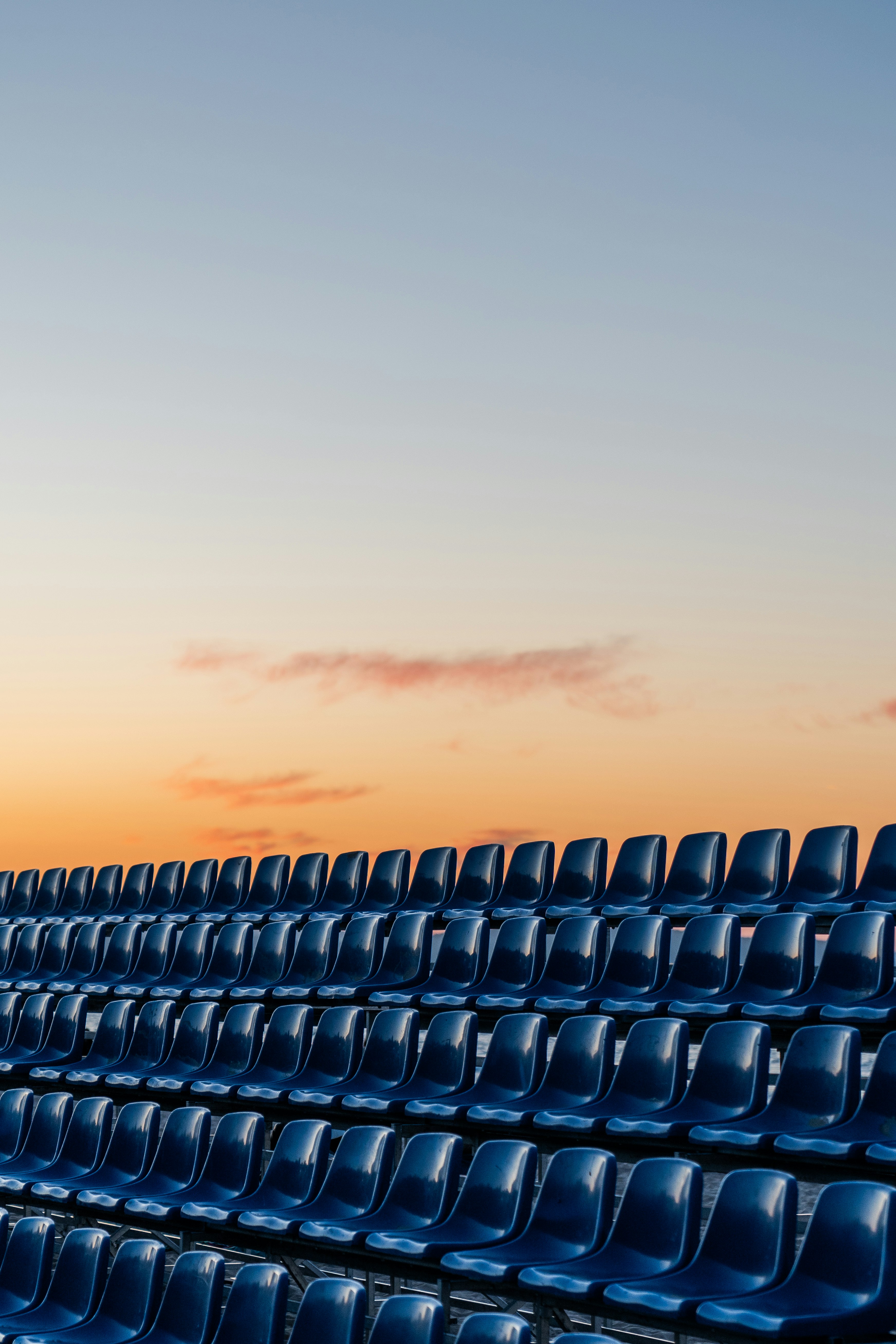 a row of blue chairs sitting next to each other