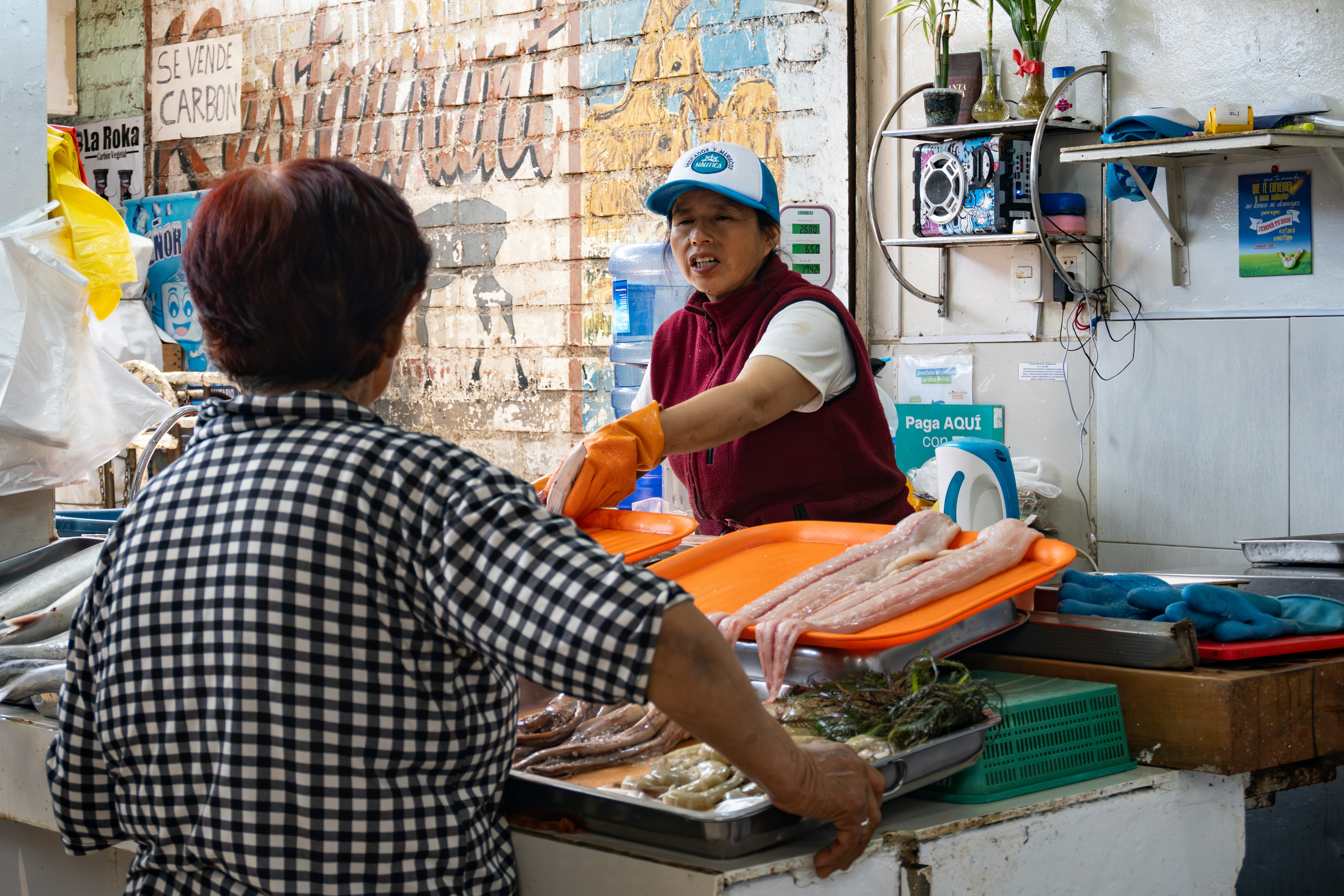 A man and a woman standing at a counter, 