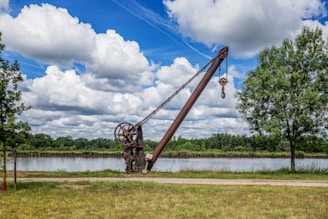 a large crane sitting on top of a lush green field