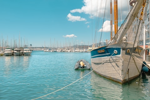 a sailboat tied to a dock in a harbor