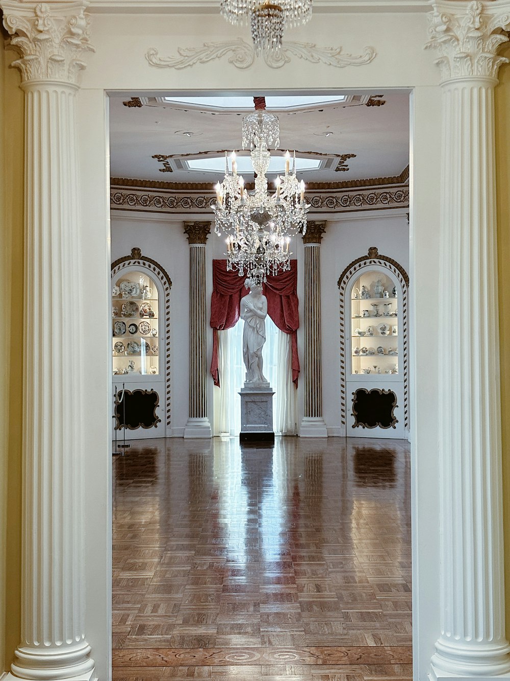 a large room with a chandelier and a statue