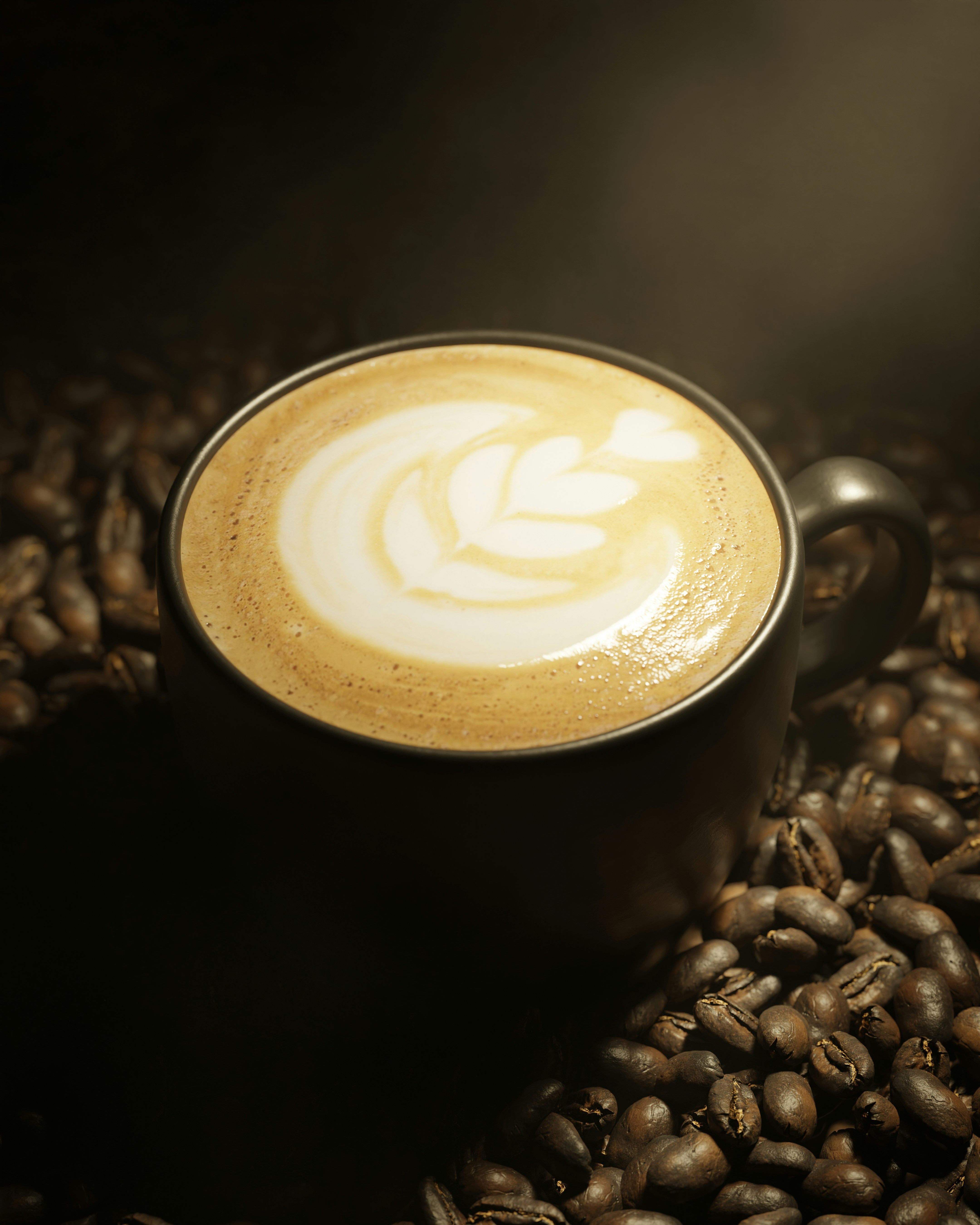 A cup of coffee with latte art surrounded by beans