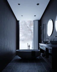 Modern dark bathroom with freestanding tub and double vanity.