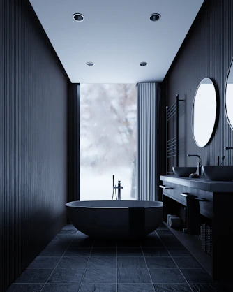 Modern dark bathroom with freestanding tub and double vanity.