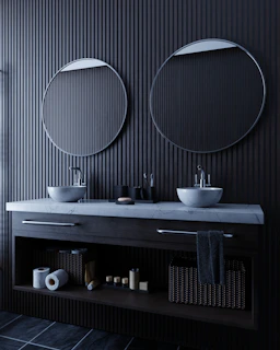 Modern bathroom vanity with two sinks and mirrors.