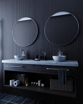 Modern bathroom vanity with two sinks and mirrors.