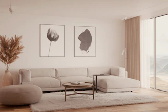 Modern living room with beige sectional sofa and art