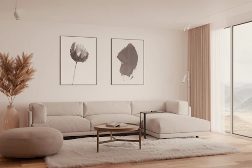 Modern living room with beige sectional sofa and art