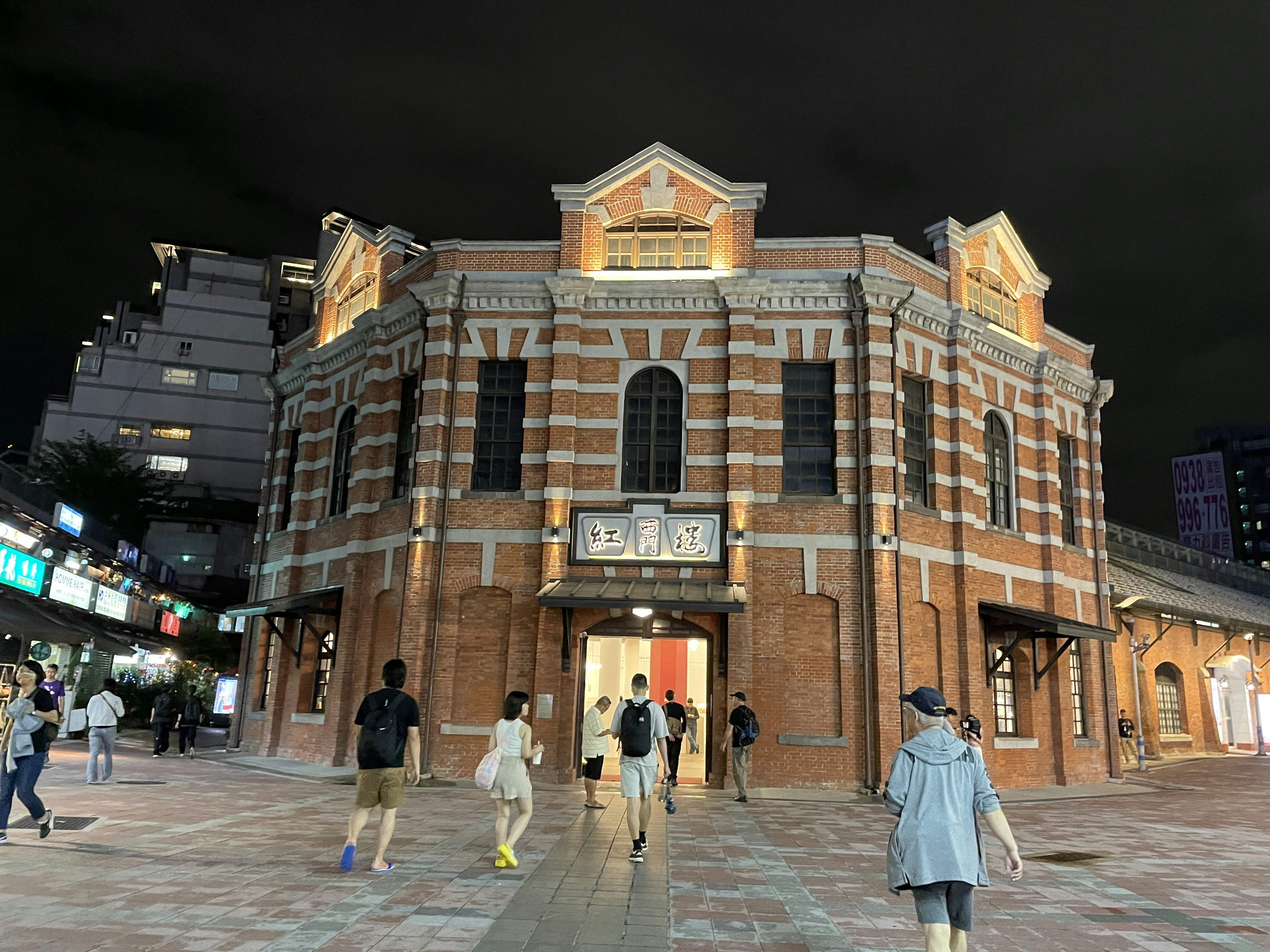 a group of people walking in front of a building