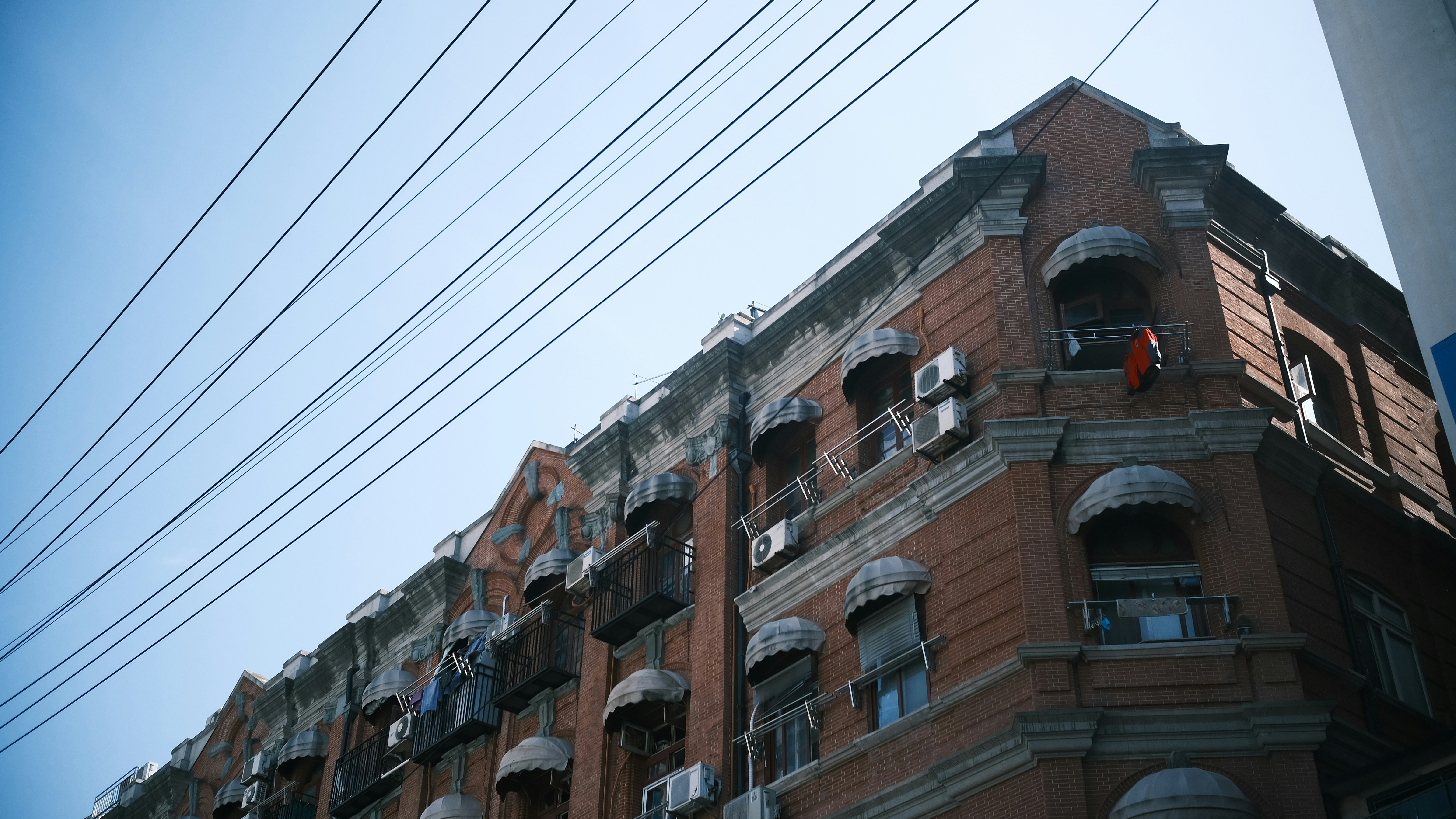 a tall brick building with lots of balconies