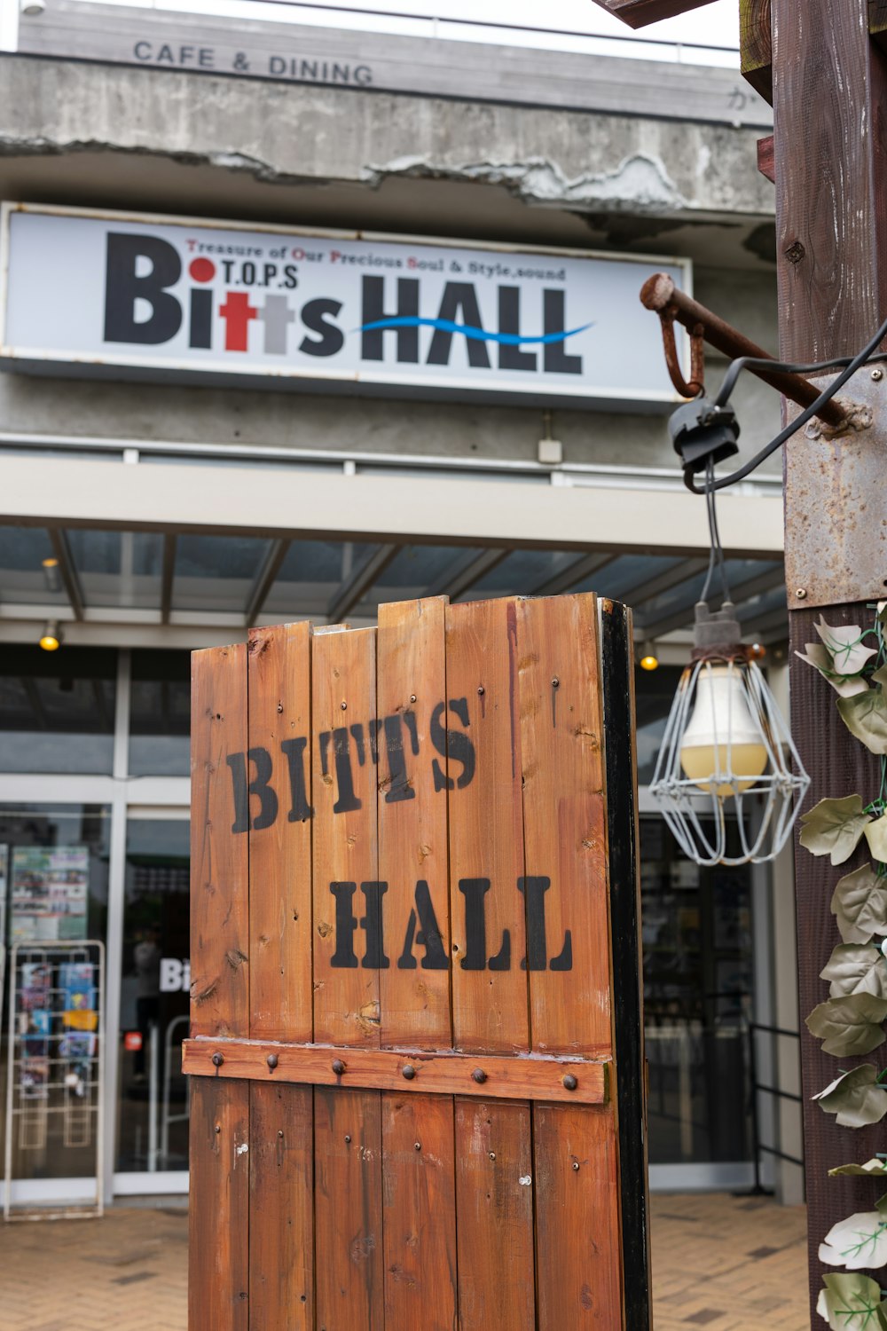 a wooden sign that says butts's hall on it