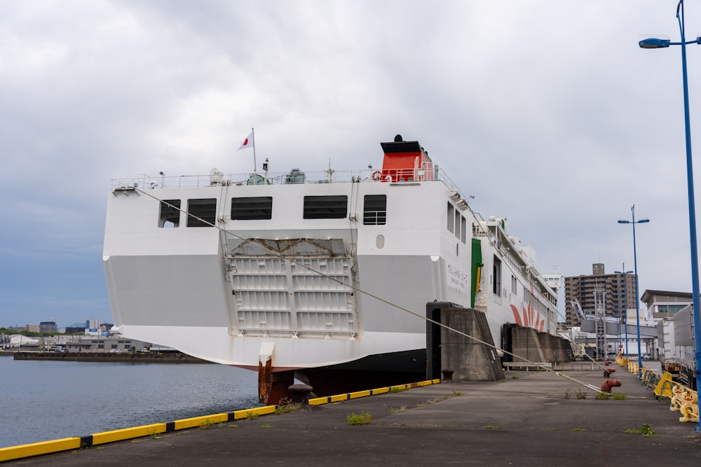 a large white boat docked at a dock