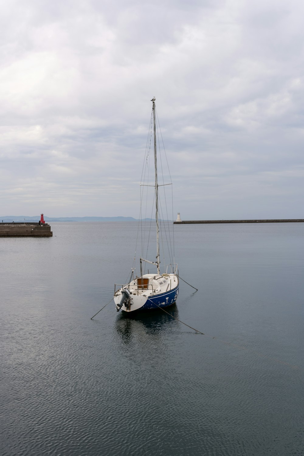 a sailboat floating in a large body of water