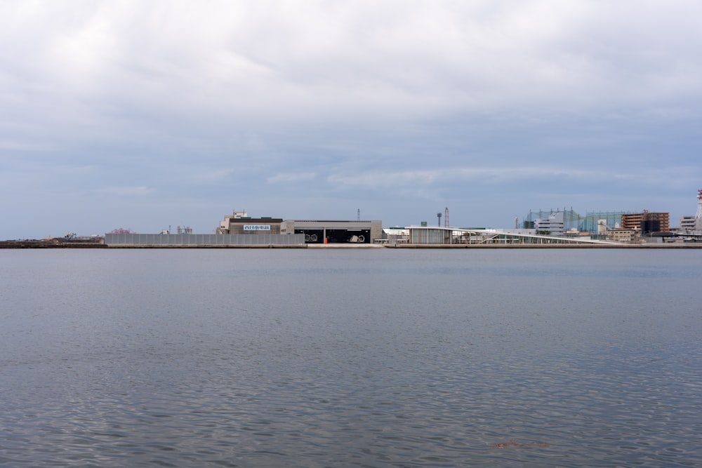 a large body of water with buildings in the background
