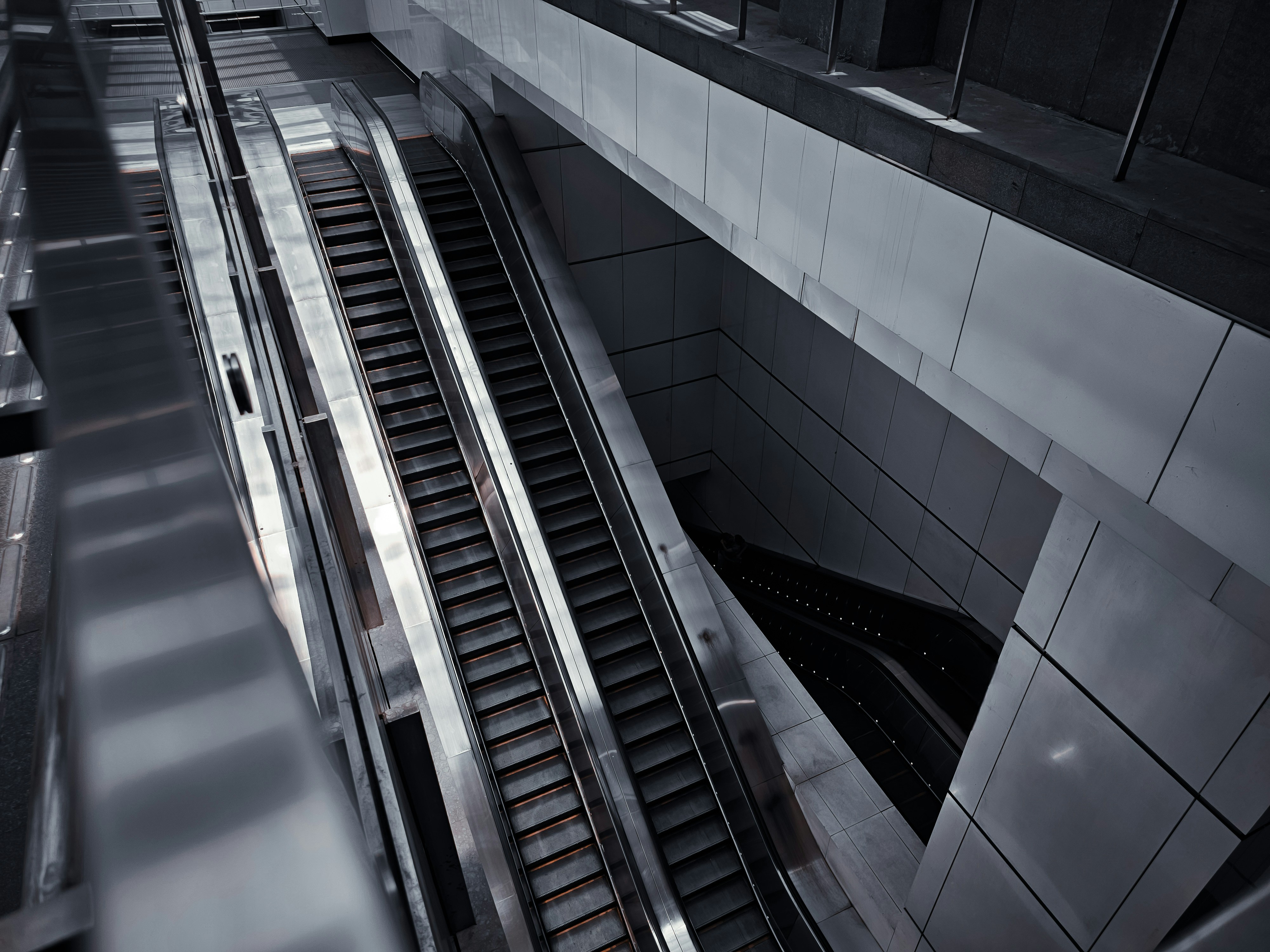 a train traveling down a train track next to a tall building