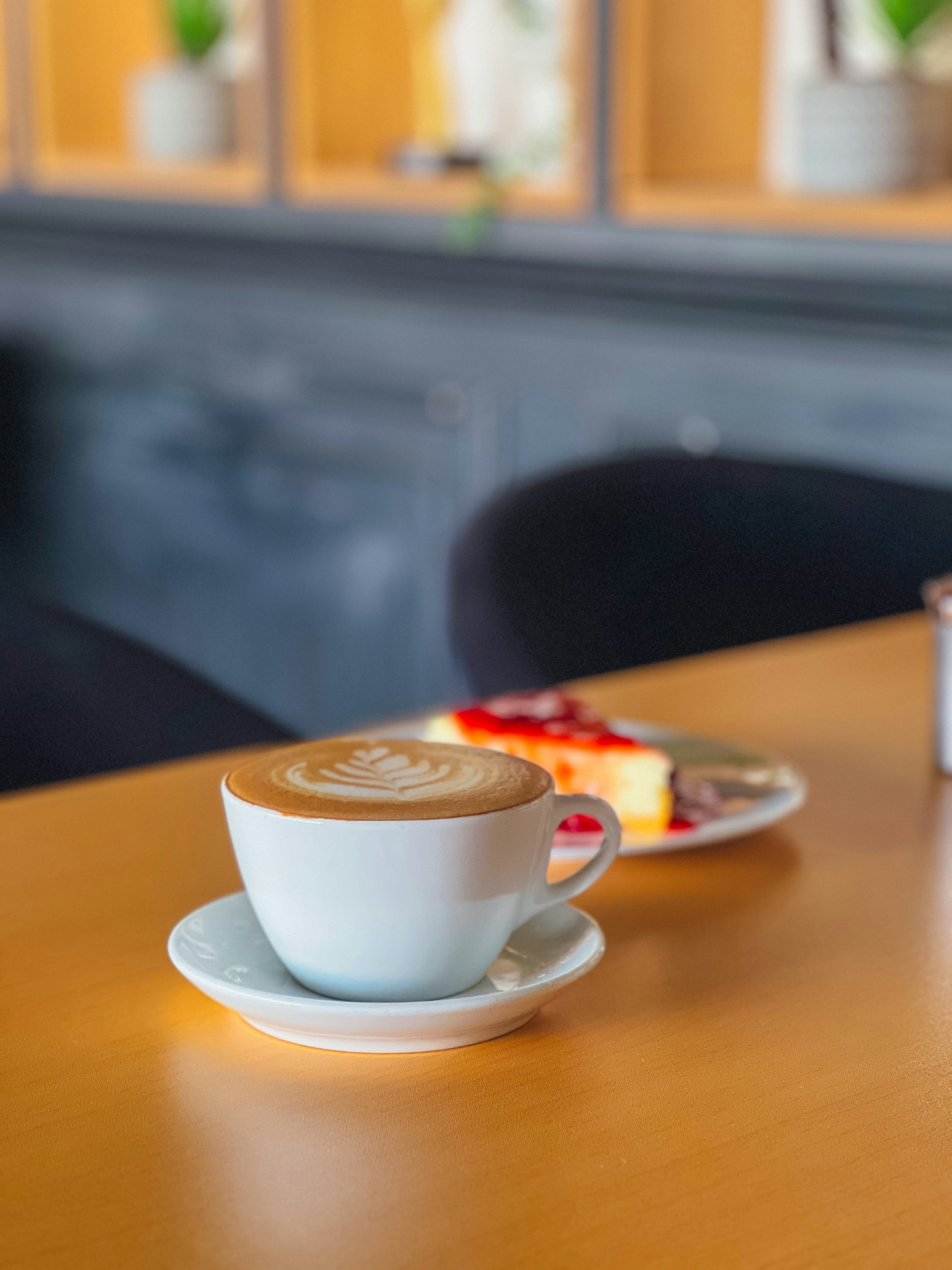 a cup of coffee sitting on top of a wooden table