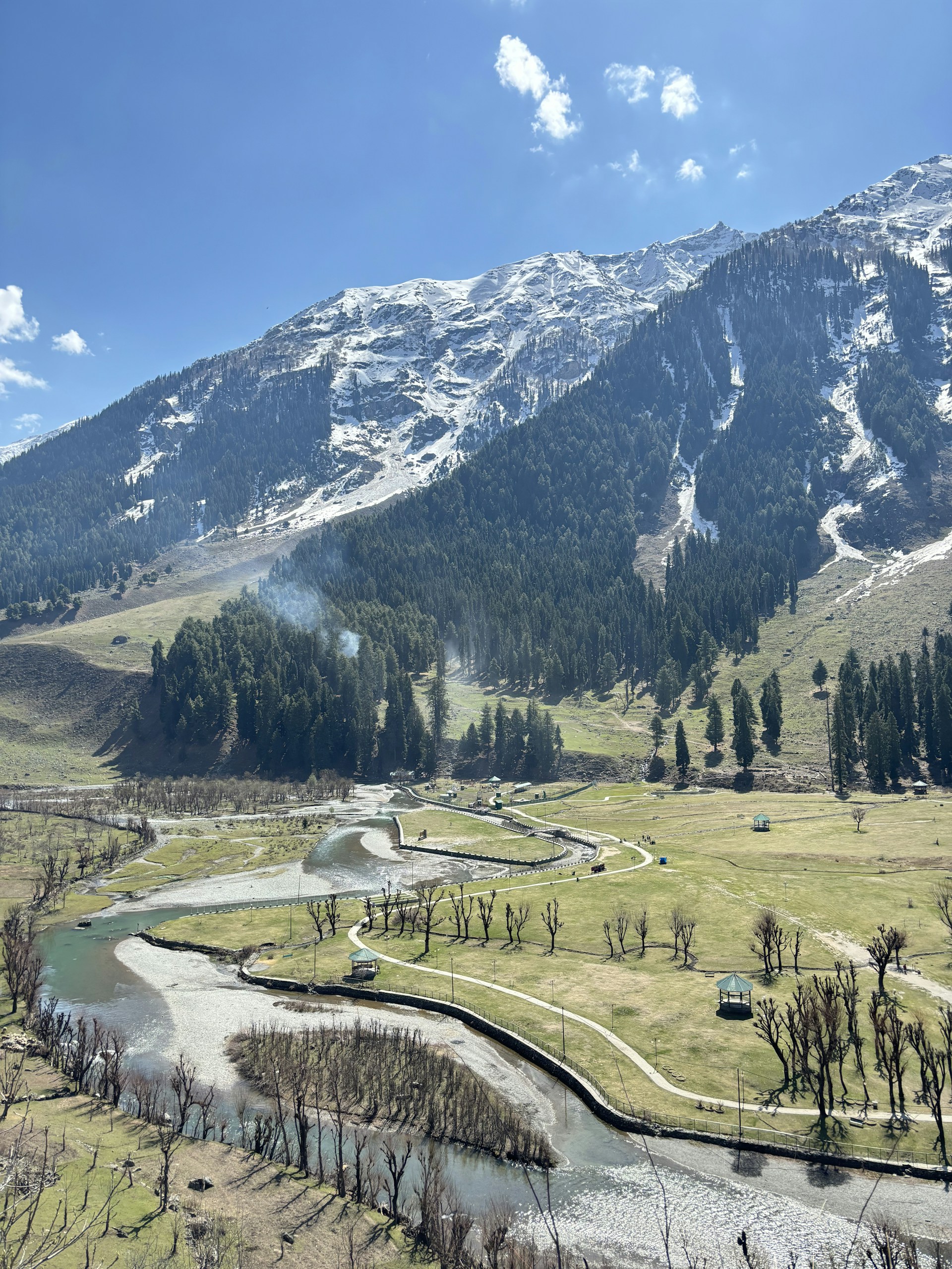 a river running through a lush green valley