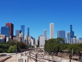 a view of a train track in front of a city skyline
