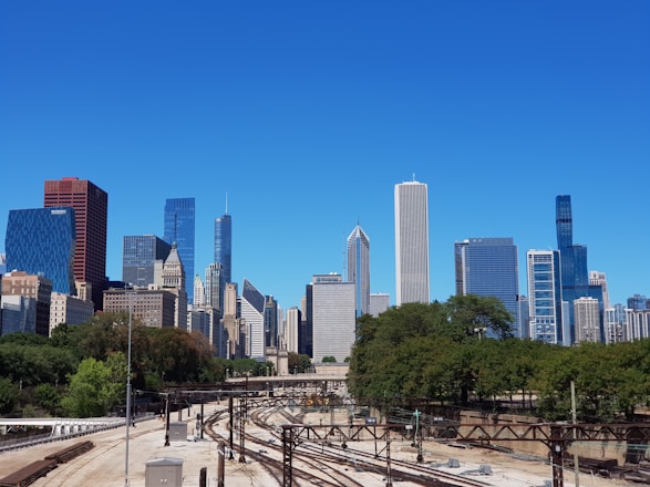a view of a train track in front of a city skyline