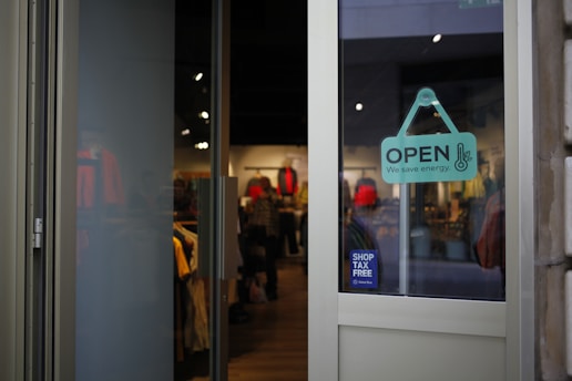 a store front with a sign that says open