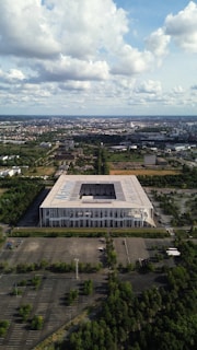 an aerial view of a large building surrounded by trees