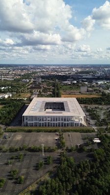 an aerial view of a large building surrounded by trees
